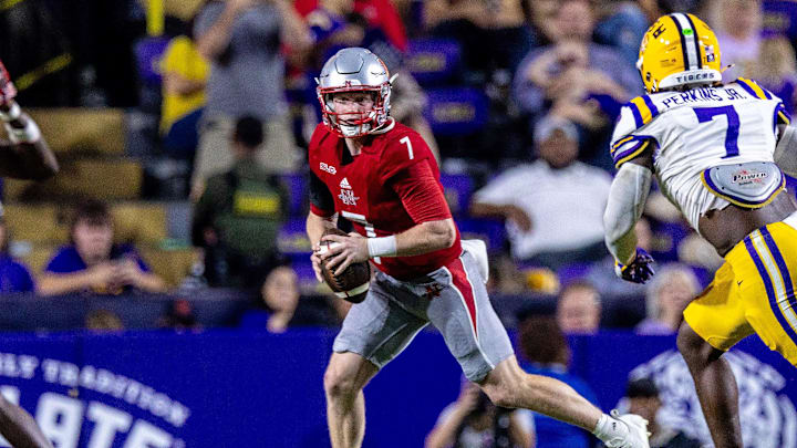 Sep 7, 2024; Baton Rouge, Louisiana, USA; Nicholls State Colonels quarterback Pat McQuaide (7) rolls out of the pocket against LSU Tigers linebacker Harold Perkins Jr. (7) during the second half at Tiger Stadium. Mandatory Credit: Stephen Lew-Imagn Images