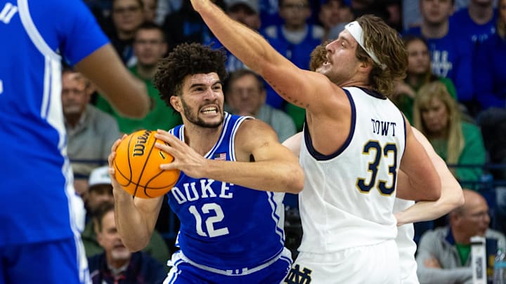 Feb 24, 2026; South Bend, Indiana, USA; Duke Blue Devils forward Cameron Boozer (12) works against Notre Dame Fighting Irish forward Carson Towt (33) during the first half at Purcell Pavilion at the Joyce Center. Mandatory Credit: Michael Caterina-Imagn Images