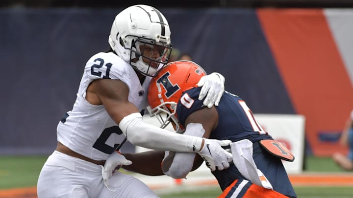Sep 16, 2023; Champaign, Illinois, USA;  Penn State Nittany Lions safety Kevin Winston Jr. (21) tackles Illinois Fighting Illini running back Josh McCray (0) after McCray caught a short pass during the second half at Memorial Stadium. Mandatory Credit: Ron Johnson-Imagn Images