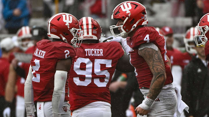Indiana linebackers Aiden Fisher (4), Jailin Walker (2) and defensive lineman Tyrique Tucker (95) celebrate a stop against Maryland.