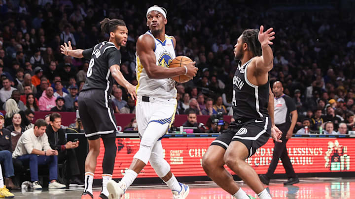 Mar 6, 2025; Brooklyn, New York, USA;  Golden State Warriors forward Jimmy Butler III (10) drives past Brooklyn Nets forward Ziaire Williams (8) and guard Cam Thomas (24) in the second quarter at Barclays Center. Mandatory Credit: Wendell Cruz-Imagn Images