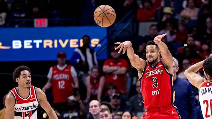 Feb 14, 2024; New Orleans, Louisiana, USA;  New Orleans Pelicans guard CJ McCollum (3) passes the ball against Washington Wizards guard Jordan Poole (13) during the second half at Smoothie King Center. Mandatory Credit: Stephen Lew-Imagn Images