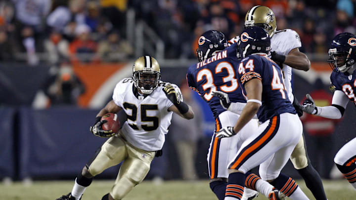 Dec 11, 2008; Chicago, IL, USA; New Orleans Saints running back Reggie Bush (25) runs with the ball as Chicago Bears cornerback Charles Tillman (33) and safety Kevin Payne (44) come in for the tackle during the first quarter at Soldier Field. Mandatory Credit: Jerry Lai-Imagn Images