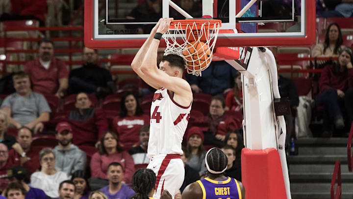 Feb 12, 2025; Fayetteville, Arkansas, USA;  Arkansas Razorbacks forward Zvonimir Ivisic (44) dunks in front of LSU Tigers guard Jordan Sears (1) and forward Corey Chest (11) during the first half at Bud Walton Arena. Arkansas won 70-58.  Mandatory Credit: Brett Rojo-Imagn Images