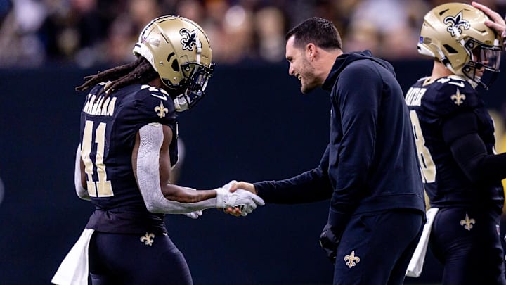 Dec 15, 2024; New Orleans, Louisiana, USA;  New Orleans Saints quarterback Derek Carr (4) shakes hands with running back Alvin Kamara (41) after a touchdown against the Washington Commanders during the second half at Caesars Superdome. Mandatory Credit: Stephen Lew-Imagn Images