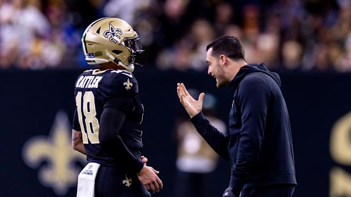 Dec 15, 2024; New Orleans, Louisiana, USA; New Orleans Saints quarterback Derek Carr (4) jokes with quarterback Spencer Rattler (18) after a touchdown against the Washington Commanders during the second half at Caesars Superdome. Mandatory Credit: Stephen Lew-Imagn Images Dec 15, 2024; New Orleans, Louisiana, USA; New Orleans Saints quarterback Derek Carr (4) jokes with quarterback Spencer Rattler (18) after a touchdown against the Washington Commanders during the second half at Caesars Superdome. Mandatory Credit: Stephen Lew-Imagn Images