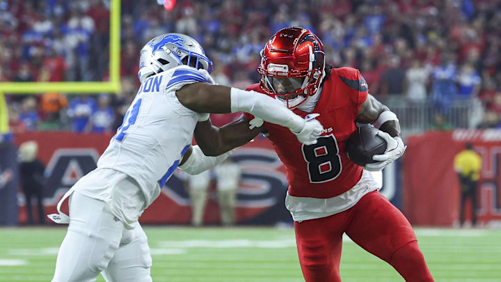 Nov 10, 2024; Houston, Texas, USA; Houston Texans wide receiver John Metchie III (8) makes a reception as Detroit Lions cornerback Amik Robertson (21) defends during the first quarter at NRG Stadium. Mandatory Credit: Troy Taormina-Imagn Images