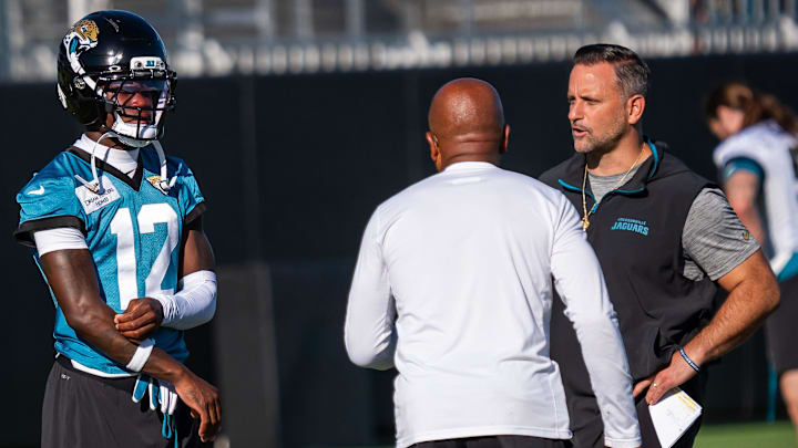 Jacksonville Jaguars wide receiver Travis Hunter (12) talks with Jaguars Defensive Coordinator Anthony Campanile, right and Jaguars Secondary Coach Ron Milus during an NFL training camp second session at the Miller Electric Center, Thursday, July 24, 2025, in Jacksonville, Fla. [Doug Engle/Florida Times-Union]