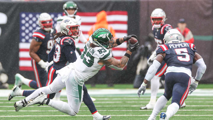 Sep 24, 2023; East Rutherford, NJ; New York Jets tight end Tyler Conklin (83) makes a catch in front of New England Patriots safety Kyle Dugger (23) and safety Jabrill Peppers (5) during the second half at MetLife Stadium 