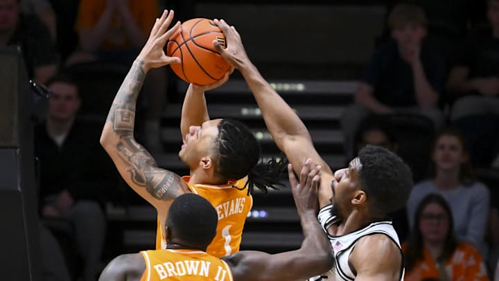 Feb 21, 2026; Nashville, Tennessee, USA;  Vanderbilt Commodores forward Ak Okereke (10) blocks the shot of Tennessee Volunteers guard Amari Evans (1) during the second half at Memorial Gymnasium. Mandatory Credit: Steve Roberts-Imagn Images
