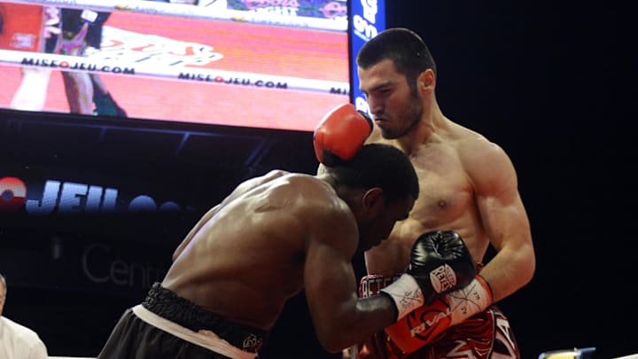 Artur Beterbiev (red trunks) engages a bitter exchange with Eddie Hearn ahead of his clash with Bivol