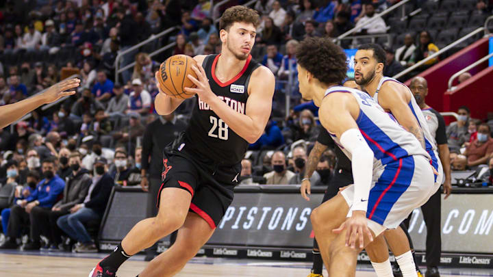 Dec 18, 2021; Detroit, Michigan, USA; Houston Rockets center Alperen Sengun (28) drives to the basket against Detroit Pistons guard Cade Cunningham (2) during the first quarter at Little Caesars Arena. Mandatory Credit: Raj Mehta-Imagn Images