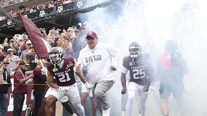 Dec 20, 2025; College Station, TX, USA; Texas A&M Aggies head coach Mike Elko takes the field prior to the game against the Miami Hurricanes during the first round of the CFP National Playoff at Kyle Field. Mandatory Credit: Maria Lysaker-Imagn Images 
