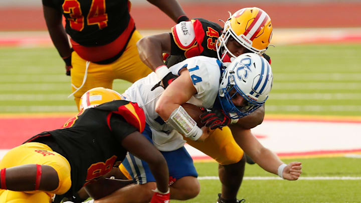 Clarke Central  s Anthony Lonon Jr (88) and Kelin Fanning (43) sack Oconee  s Titus Watkins (14) during a GHSA high school football game on Friday, Aug. 25, 2023.