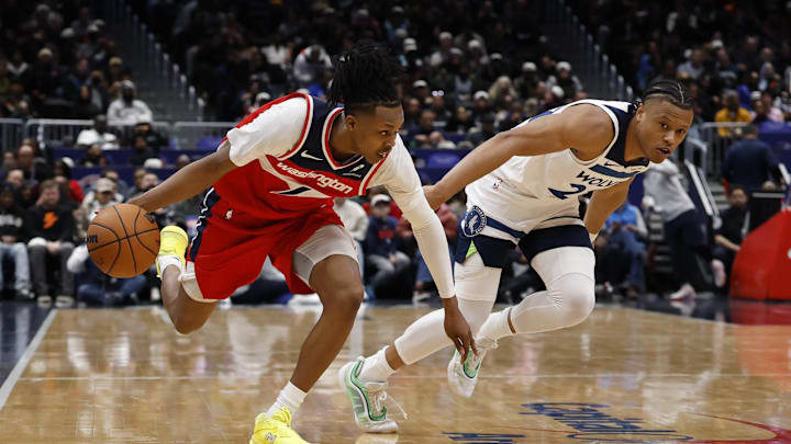Jan 4, 2026; Washington, District of Columbia, USA; Washington Wizards guard Bub Carrington (7) drives to the basket as Minnesota Timberwolves guard Jaylen Clark (22) defends in the second quarter at Capital One Arena. Mandatory Credit: Geoff Burke-Imagn Images