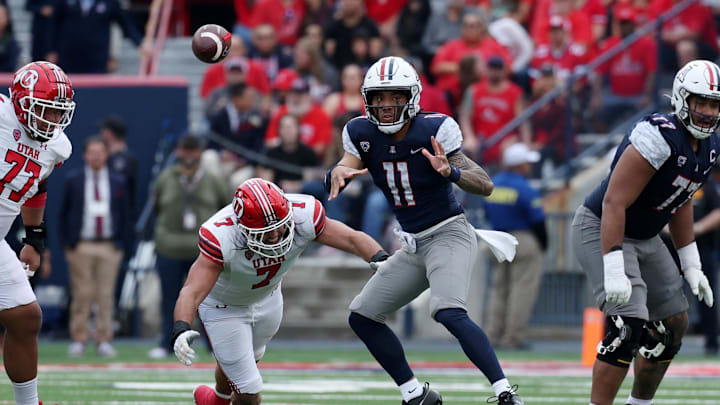 Nov 18, 2023; Tucson, Arizona, USA; Arizona Wildcats quarterback Noah Fifita (11) throws a pass against Utah Utes defensive end Van Fillinger (7) during the second half at Arizona Stadium. Mandatory Credit: Zachary BonDurant-Imagn Images