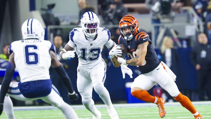 Dec 9, 2024; Arlington, Texas, USA;  Cincinnati Bengals running back Chase Brown (30) runs with the ball as Dallas Cowboys linebacker DeMarvion Overshown (13) defends during the second half at AT&T Stadium. Mandatory Credit: Kevin Jairaj-Imagn Images