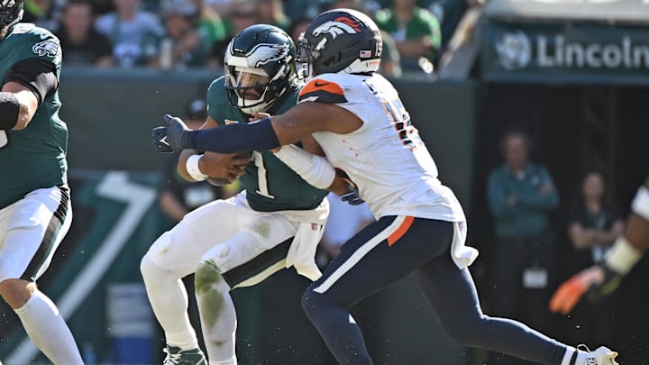 Oct 5, 2025; Philadelphia, Pennsylvania, USA; Philadelphia Eagles quarterback Jalen Hurts (1) is sacked by Denver Broncos linebacker Nik Bonitto (15) at Lincoln Financial Field. Mandatory Credit: Eric Hartline-Imagn Images