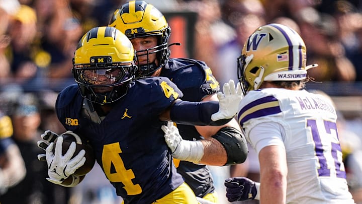 Michigan wide receiver Andrew Marsh (4) runs against Washington safety Alex McLaughlin (12) during the first half at Michigan Stadium in Ann Arbor on Saturday, Oct. 18, 2025.
