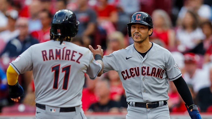 Aug 15, 2023; Cincinnati, Ohio, USA; Cleveland Guardians left fielder Steven Kwan (38) high fives third baseman Jose Ramirez (11) after scoring on a two-run single hit by first baseman Kole Calhoun (not pictured) in the first inning against the Cincinnati Reds at Great American Ball Park. Mandatory Credit: Katie Stratman-Imagn Images