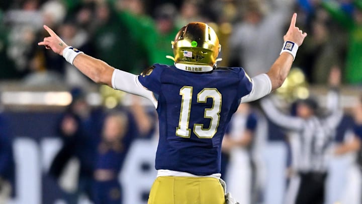 Nov 16, 2024; South Bend, Indiana, USA; Notre Dame Fighting Irish quarterback Riley Leonard (13) reacts after a Notre Dame touchdown against the Virginia Cavaliers in the third quarter at Notre Dame Stadium. Mandatory Credit: Matt Cashore-Imagn Images