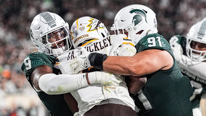 Michigan State defensive lineman Jalen Thompson (9), left, and defensive lineman Alex VanSumeren (91) tackle Western Michigan running back Jalen Buckley (6) for a safety during the second half at Spartan Stadium in East Lansing on Friday, August 29, 2025. Michigan State defensive lineman Jalen Thompson (9), left, and defensive lineman Alex VanSumeren (91) tackle Western Michigan running back Jalen Buckley (6) for a safety during the second half at Spartan Stadium in East Lansing on Friday, August 29, 2025.