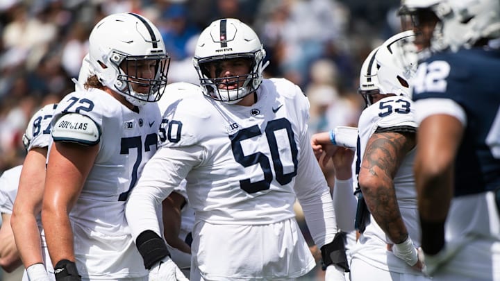 Penn State offensive linemen Nolan Rucci (72) and Cooper Cousins (50) talk before a play during the Blue-White game at Beaver Stadium on Saturday, April 13, 2024, in State College.