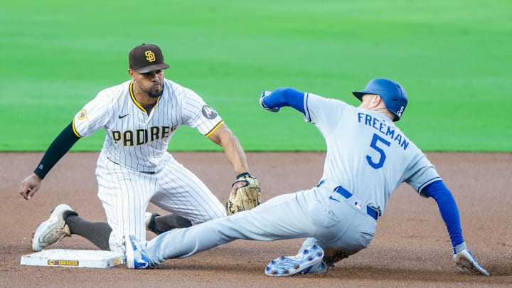 Jun 9, 2025; San Diego, California, USA; Los Angeles Dodgers first baseman Freddie Freeman (5) slides under the tag of San Diego Padres shortstop Xander Bogaerts (2) for a double during the first inning against the San Diego Padres at Petco Park. Mandatory Credit: David Frerker-Imagn Images
