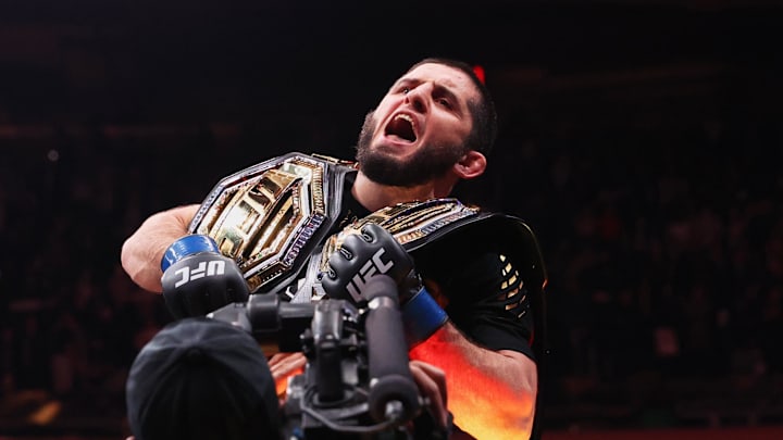 Nov 15, 2025; New York, NY, UNITED STATES; Islam Makhachev (blue gloves) celebrates after defeating Jack Della Maddalena (not pictured) by unanimous decision in the welterweight championship bout during UFC 322 at Madison Square Garden. Mandatory Credit: Ed Mulholland-Imagn Images