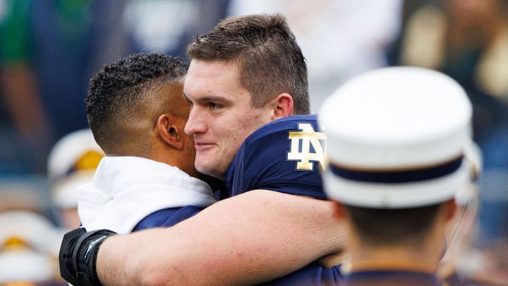 Notre Dame offensive lineman Pat Coogan, right, hugs head coach Marcus Freeman before a NCAA college football game against Virginia at Notre Dame Stadium on Saturday, Nov. 16, 2024, in South Bend. Notre Dame offensive lineman Pat Coogan, right, hugs head coach Marcus Freeman before a NCAA college football game against Virginia at Notre Dame Stadium on Saturday, Nov. 16, 2024, in South Bend.