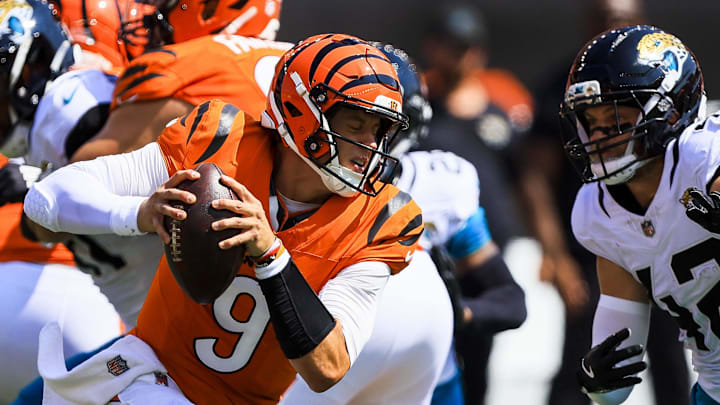 Sep 14, 2025; Cincinnati, Ohio, USA; Cincinnati Bengals quarterback Joe Burrow (9) runs with the ball against the Jacksonville Jaguars in the first half at Paycor Stadium. 