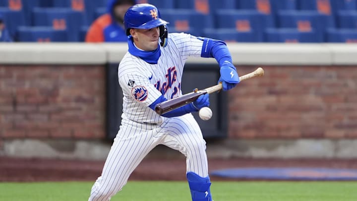 Apr 4, 2024; New York City, New York, USA; New York Mets third baseman Zack Short (21) lays down a sacrifice bunt against the Detroit Tigers during the eighth inning at Citi Field. Mandatory Credit: Gregory Fisher-Imagn Images