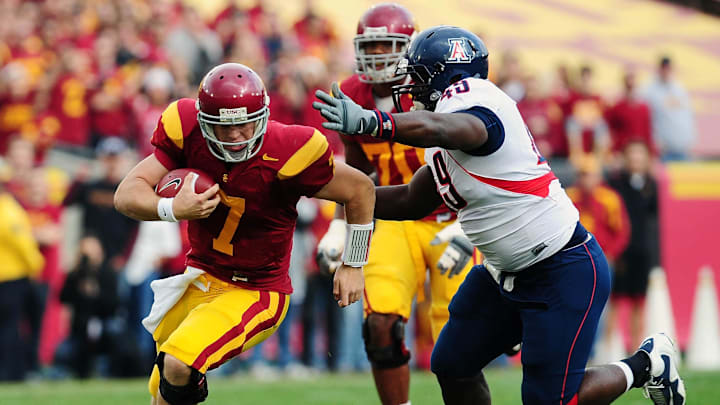 December 5, 2009; Los Angeles, CA, USA; Southern California Trojans quarterback Matt Barkley (7) runs the ball against the defense of Arizona Wildcats defensive tackle Earl Mitchell (49) during the first half at the Los Angeles Memorial Coliseum. Mandatory Credit: Gary A. Vasquez-Imagn Images