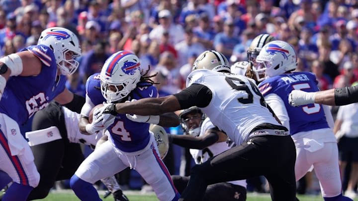 Buffalo Bills running back James Cook runs the ball during first half action of the Bills home game against the New Orleans Saints in Orchard Park on Sept. 28, 2025. Saints Cameron Jordan reaches out to tackle him.