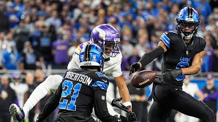 Detroit Lions cornerback Amik Robertson (21), left, and safety Ifeatu Melifonwu (6) break a pass intended for Minnesota Vikings wide receiver Justin Jefferson (18) during the second half at Ford Field in Detroit on Sunday, Jan. 5, 2025.