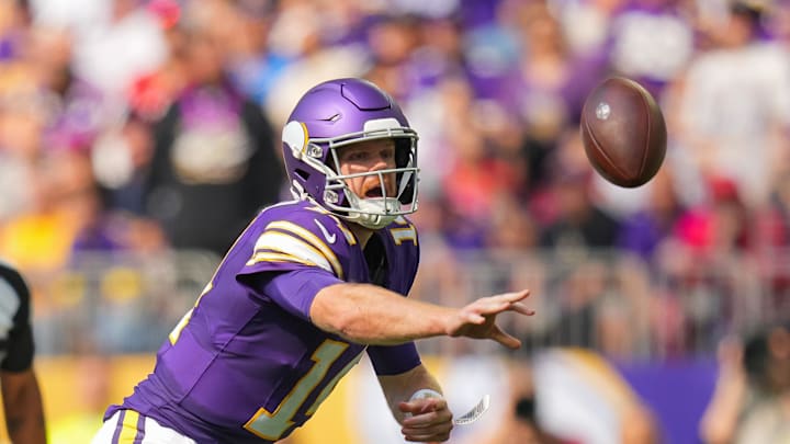Sep 22, 2024; Minneapolis, Minnesota, USA; Minnesota Vikings quarterback Sam Darnold (14) pitches the ball against the Houston Texans in the third quarter at U.S. Bank Stadium.