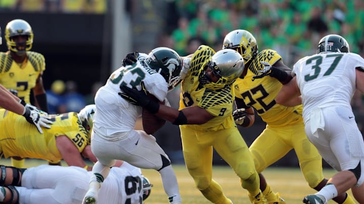 Sep 6, 2014; Eugene, OR, USA; Michigan State Spartans running back Jeremy Langford (33) is tackled by Oregon Ducks defensive lineman Arik Armstead (9) at Autzen Stadium. Mandatory Credit: Scott Olmos-USA TODAY Sports