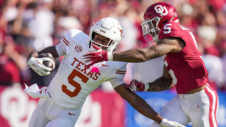 Texas Longhorns wide receiver Ryan Wingo (5) runs for the first down against Oklahoma Sooners defensive back Woodi Washington (5) in the second quarter during the Red River Rivalry Football Game between the University of Oklahoma Sooners and the University of Texas Longhorns at the Cotton Bowl Stadium in Dallas, TX on Saturday Oct. 12, 2024.