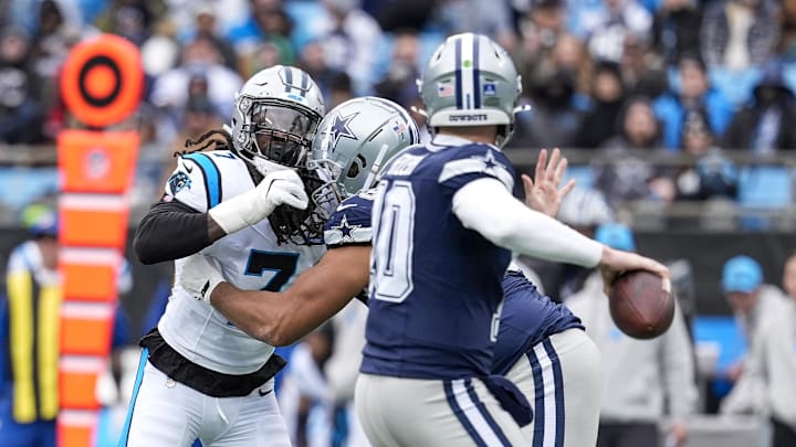 Dec 15, 2024; Charlotte, North Carolina, USA; Carolina Panthers linebacker Jadeveon Clowney (7) rushes Dallas Cowboys quarterback Cooper Rush (10) during the second quarter at Bank of America Stadium. Mandatory Credit: Jim Dedmon-Imagn Images