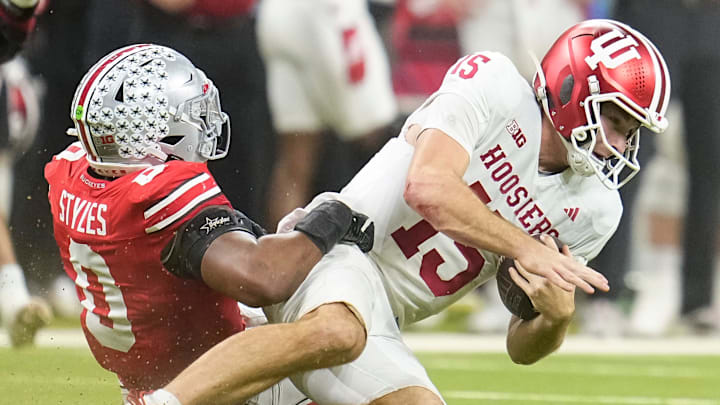 Ohio State Buckeyes linebacker Sonny Styles (0) hits Indiana Hoosiers quarterback Fernando Mendoza (15) during the first half of the Big Ten Conference championship game at Lucas Oil Stadium in Indianapolis on Dec. 6, 2025.