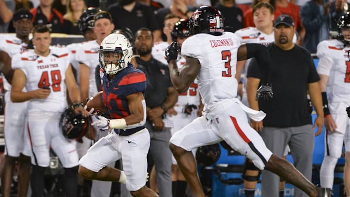 Sep 14, 2019; Tucson, AZ, USA; Arizona Wildcats running back Darrius Smith (20) runs the ball under pressure from Texas Tech Red Raiders defensive back Douglas Coleman III (3) during the second half at Arizona Stadium. Mandatory Credit: Casey Sapio-Imagn Images