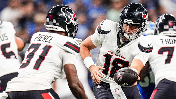 Houston Texans quarterback Graham Mertz (18) hands the ball to running back Dameon Pierce (31) against Detroit Lions during the first half at Ford Field in Detroit on Saturday, August 23, 2025.
