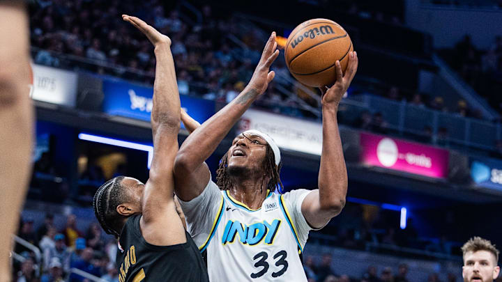Apr 10, 2025; Indianapolis, Indiana, USA; Indiana Pacers center Myles Turner (33) shoots the ball while Cleveland Cavaliers forward Isaac Okoro (35) defends in the second half at Gainbridge Fieldhouse. Mandatory Credit: Trevor Ruszkowski-Imagn Images