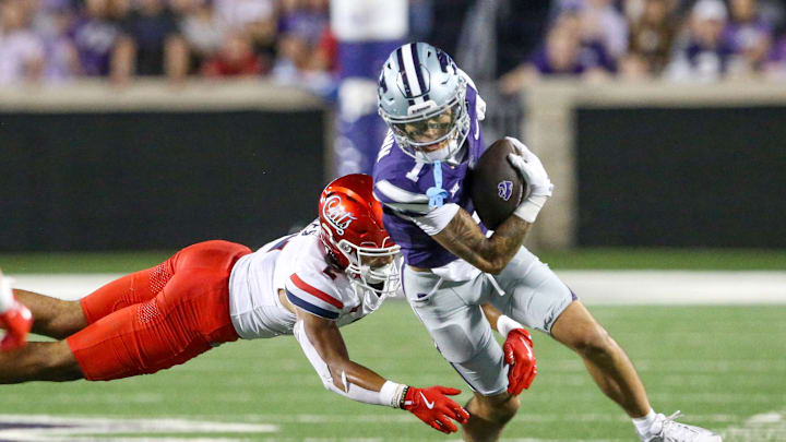 Sep 13, 2024; Manhattan, Kansas, USA; Kansas State Wildcats wide receiver Jayce Brown (1) runs away from Arizona Wildcats defensive back Treydan Stukes (2) during the fourth quarter at Bill Snyder Family Football Stadium. Mandatory Credit: Scott Sewell-Imagn Images Sep 13, 2024; Manhattan, Kansas, USA; Kansas State Wildcats wide receiver Jayce Brown (1) runs away from Arizona Wildcats defensive back Treydan Stukes (2) during the fourth quarter at Bill Snyder Family Football Stadium. Mandatory Credit: Scott Sewell-Imagn Images