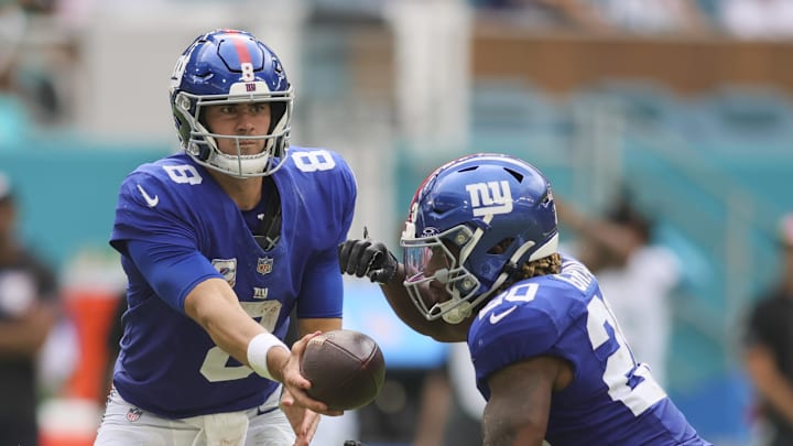 Oct 8, 2023; Miami Gardens, Florida, USA; New York Giants quarterback Daniel Jones (8) hands the