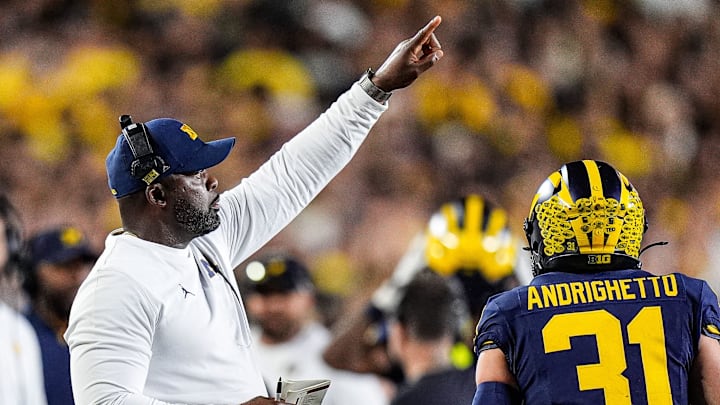 Michigan linebackers coach Brian Jean-Mary signals players before a play against New Mexico during the first half at Michigan Stadium in Ann Arbor on Saturday, August 30, 2025.
