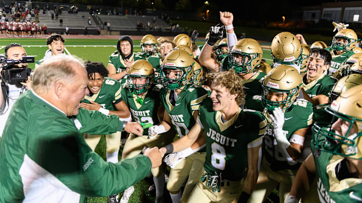 Jesuit coach Ken Potter celebrates with his players after earning his state-record 353rd victory.