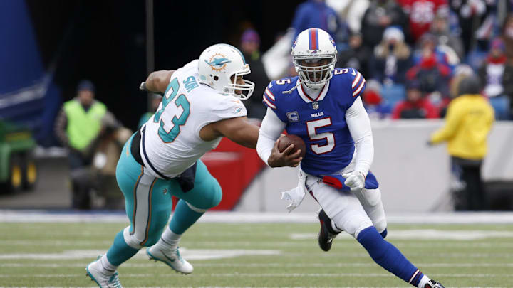 Dec 17, 2017; Orchard Park, NY, USA; Miami Dolphins defensive tackle Ndamukong Suh (93) dives to try and tackle Buffalo Bills quarterback Tyrod Taylor (5) as he runs the ball during the second half at New Era Field. Buffalo beats Miami 24 to 16. 