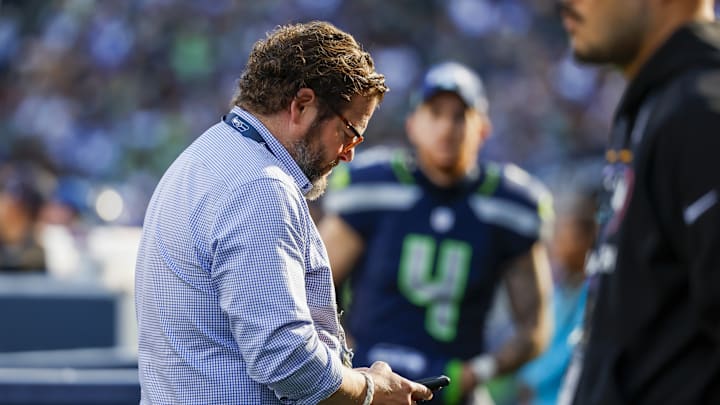 Oct 6, 2024; Seattle, Washington, USA; Seattle Seahawks general manager John Schneider looks at his phone during the fourth quarter against the New York Giants at Lumen Field. 
