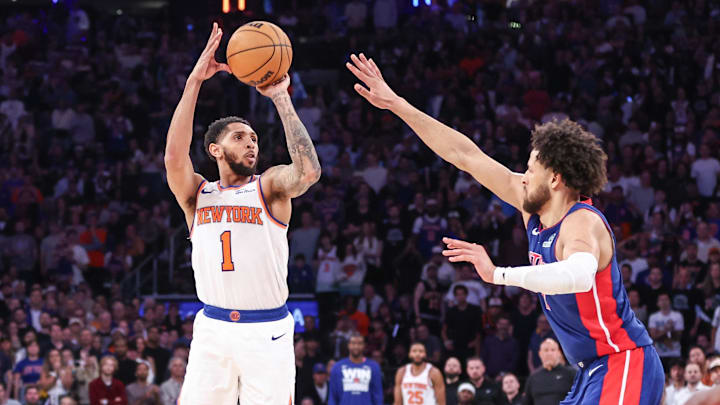 New York Knicks guard Cameron Payne takes a three point shot past Detroit Pistons guard Cade Cunningham. Mandatory Credit: Wendell Cruz-Imagn Images